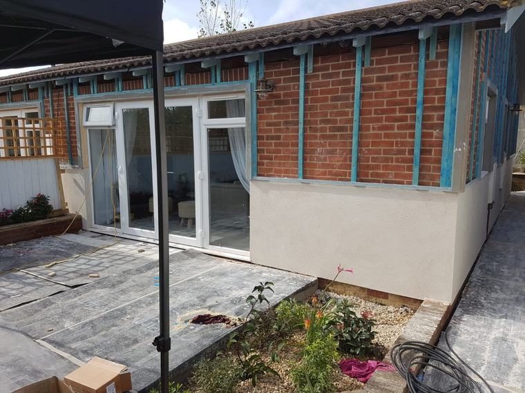 Brick exterior with blue battens for cladding preparation